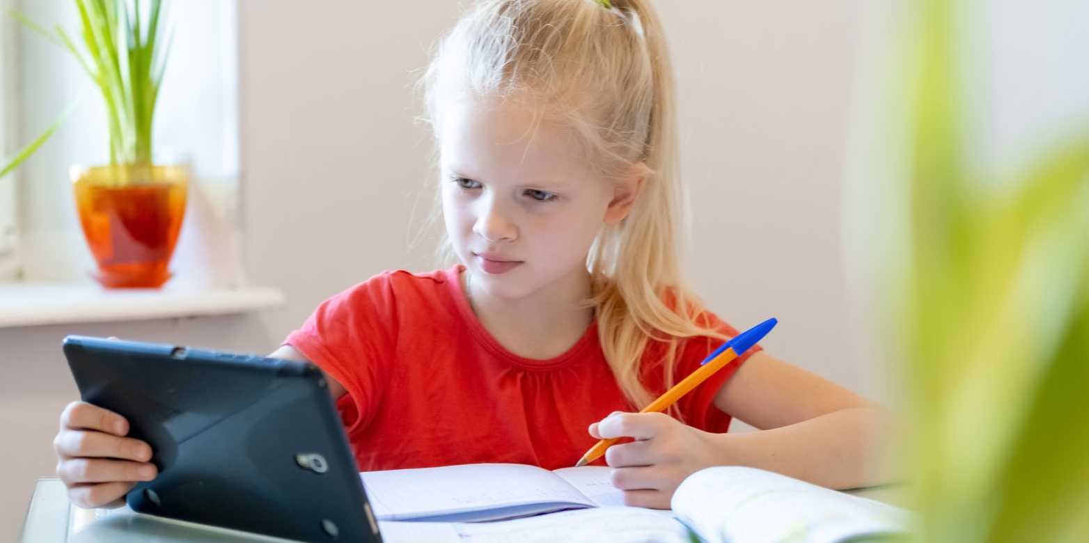 Girl learning with tablet, pen and notebook